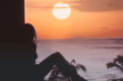 Woman lounging at sunset
